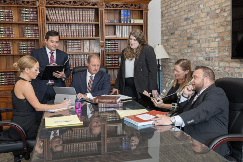 Group of professionals gathered around conference room table